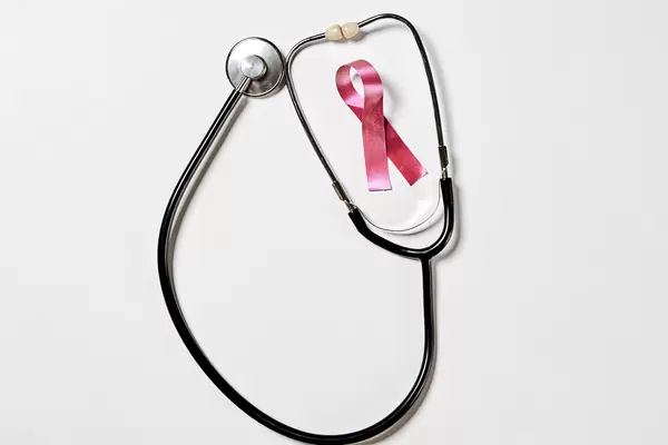 A ribbon and stethoscope. Healthcare, medicine and cancer awareness concept