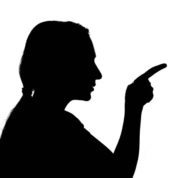 A sad woman silhouette pointing with the finger