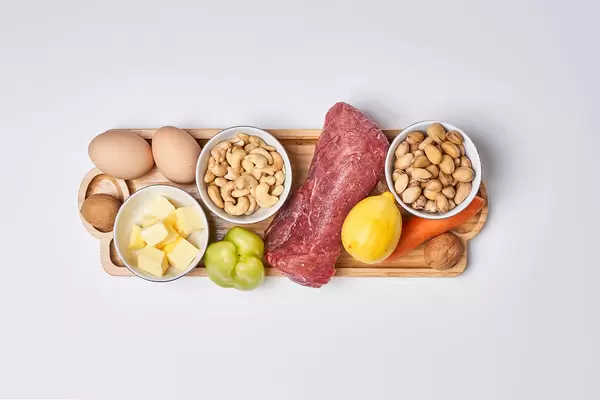 A set of healthy food - meat, nuts, protein, vegetables and fruits on white background. Top view