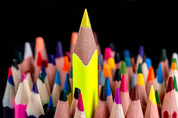 A sharp yellow pencil towers over many others