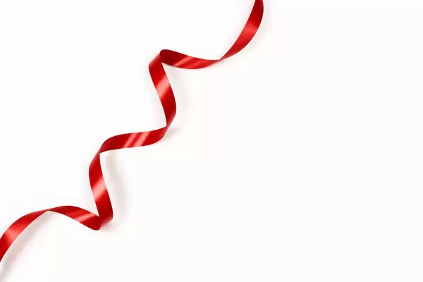 A single red ribbon on the white background with copy space