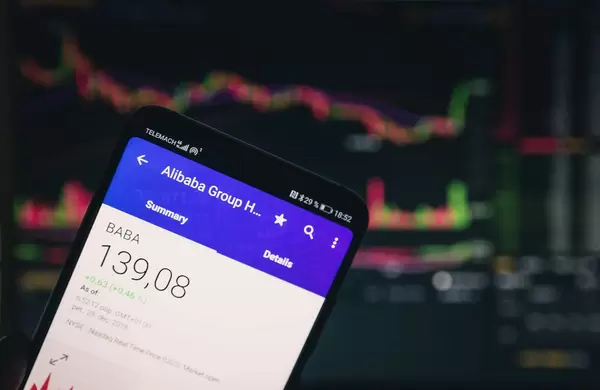 A smartphone displays the Alibaba market value