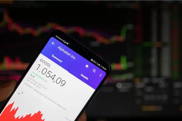A smartphone displays the Alphabet market value