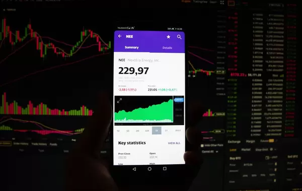 A smartphone displays the NextEra Energy market value