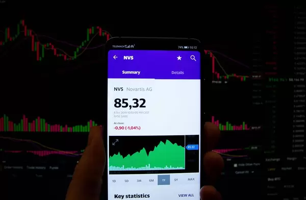 A smartphone displays the Novartis AG market value