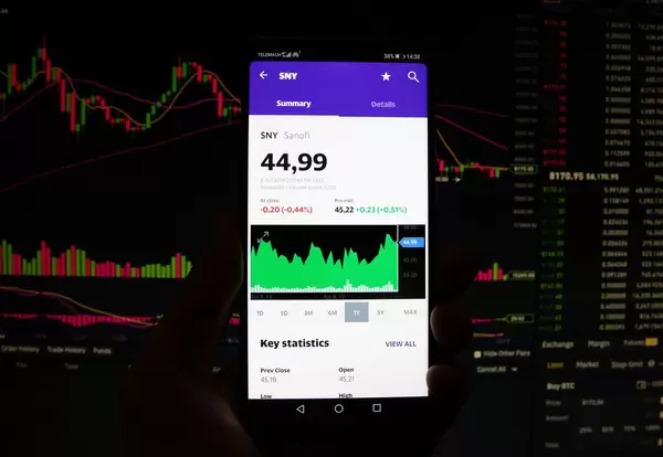 A smartphone displays the Sanofi market value