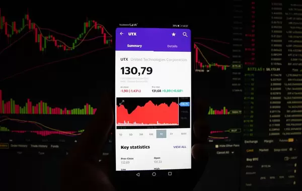 A smartphone displays the United Technologies Corporation market value