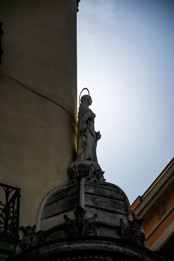 A statue of a saint on a building in Barcelona, Spain