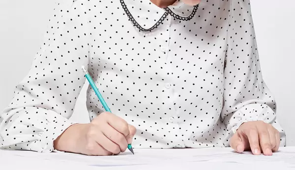 A student taking educational admission test in the class
