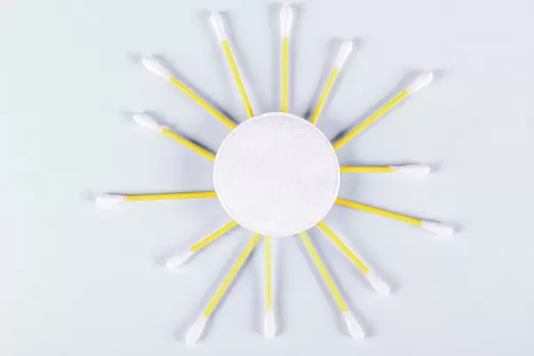A sun made from a cotton pad and cotton swabs