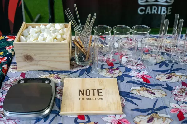 A Table at a Weekend Market set up as a Perfume Blending Station with different Laboratory Glassware, a Scale and a Wooden Box with Soap