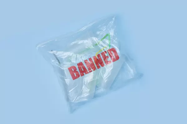 A transparent bag full of plastic sing-use mugs with Banned stamp