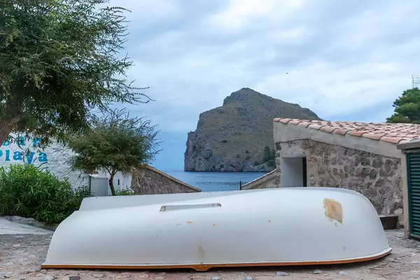 A white boat upside down in the village of Port de Sa Calobra on the northwest coast of Majorca