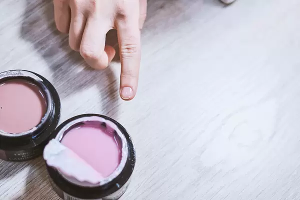 A woman in a manicure salon choosing nail color for applying