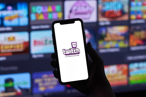 A young gamer playing online video games while streaming on social media