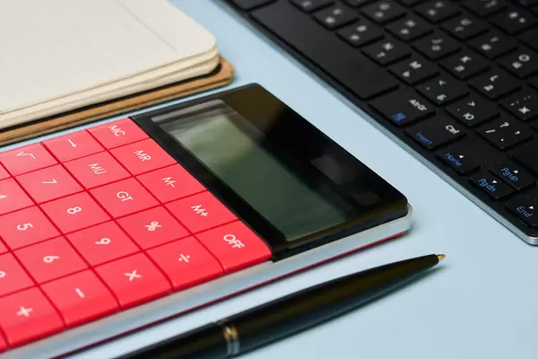 Accountant's working place with calculator and notepad