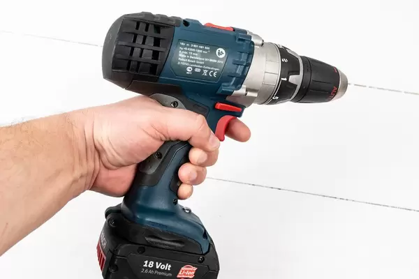 Accu Drill in the hand above white background