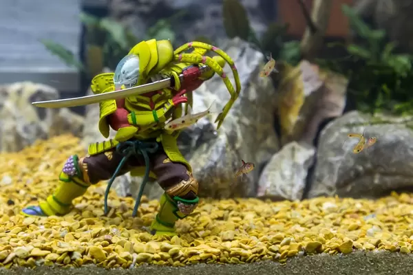 Action figure and fish in an aquarium