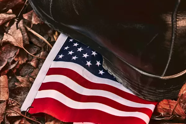 Activists trample a US flag in the dirt