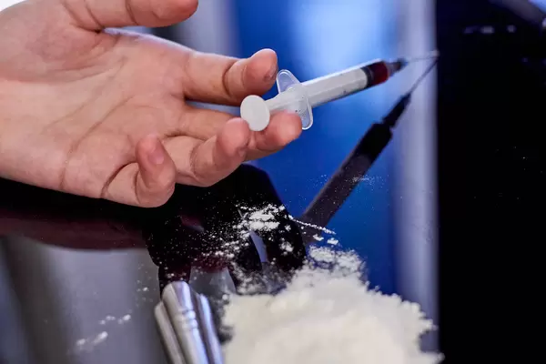 Addict man dead after inject drug overdose with syringe injection heroin to hand