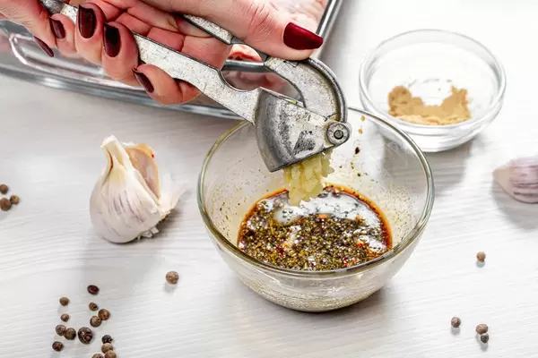 Adding garlic to spicy marinade close up (Flip 2019)