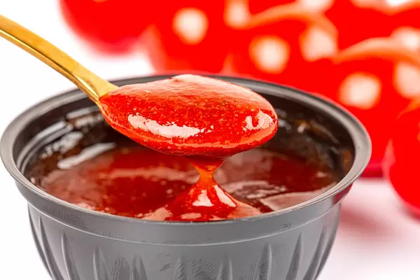 Adjika sauce in a teaspoon, close-up