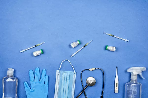 Administration of Covid-19 vaccine: three vaccine doses with syringe and medical equipment