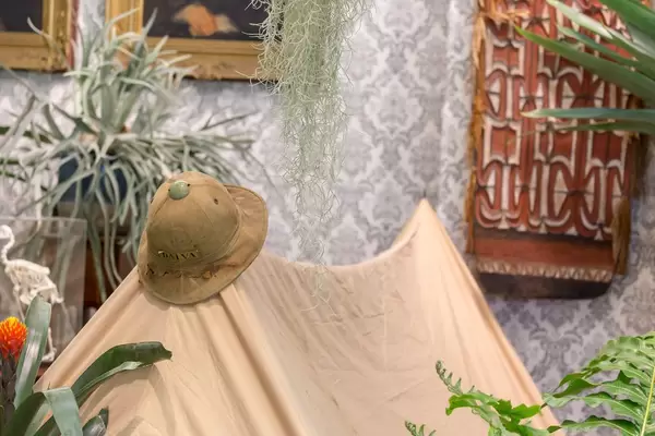 Adventure setting at Dalva booth with tent, hat and different plants