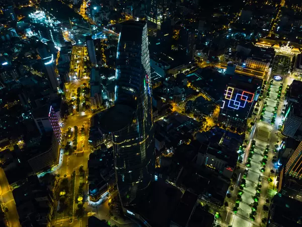 Aerial Drone Night Photo of Bitexco Financial Tower with Heli Pad next to Nguyen Hue Walking Street in Ho Chi Minh City, Vietnam