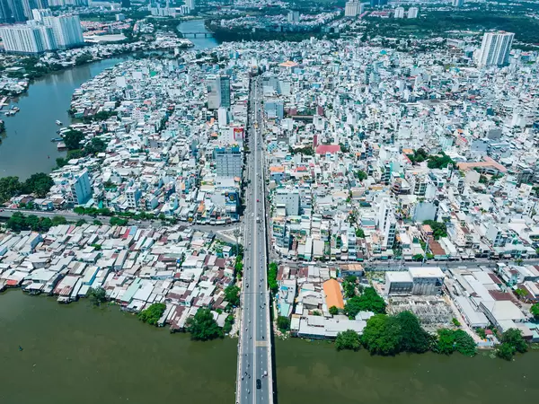 Aerial Drone Photo of a Bridge over Saigon River leading into District 8 with many Buildings in Ho Chi Minh City