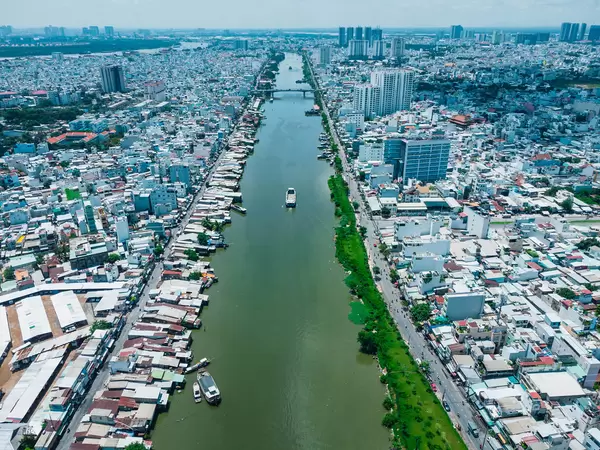 Aerial Drone Photo of Boats on Saigon River between District 4 and District 7 going towards a Bridge in Ho Chi Minh City, Vietnam