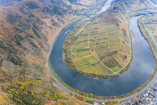 Aerial Drone Photo of Cargo Ship on Moselle River at Moselschleife with Hill Calmont and Town Bremm in Germany