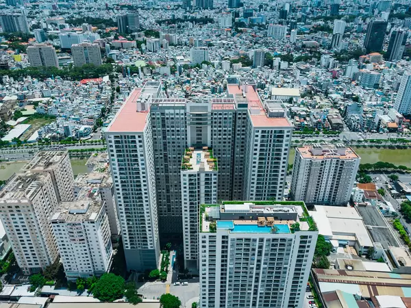 Aerial Drone Photo of Gold View Apartment Building with Rooftop Swimming Pool and Hangout Area for Residents at Saigon River in District 4 in Ho Chi Minh City, Vietnam