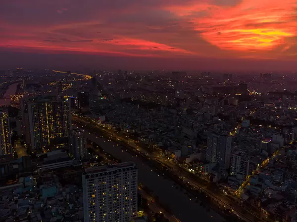 Aerial Drone Photo with Red Sunset Sky,  Buildings and Traffic Lights around Saigon River of Ho Chi Minh City, Vietnam