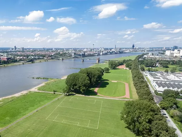 Aerial Drone Shot of Poller Wiesen Park next to Rhein River with Cologne Skyline in the Background