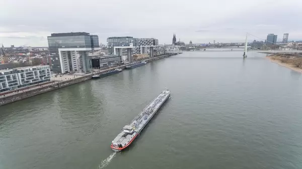 Aerial of ship in front of Kranhaus buildings on rhine river