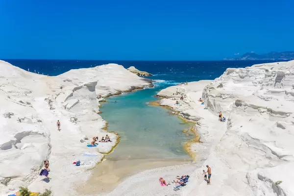 Aerial photo of the crystal clear waters of Milos. The narrow bay of Sarakiniko with few tourists