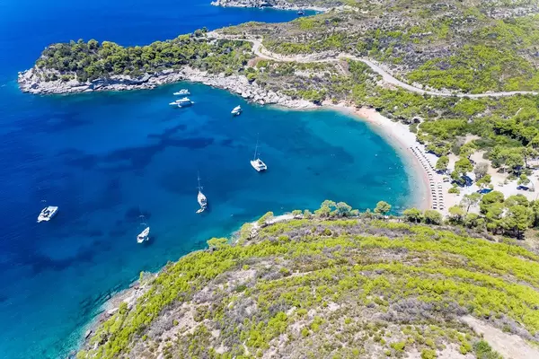 Aerial photo with view from the steep coast, to expensive yachts in the bay at Plaza Paraskevi Beach