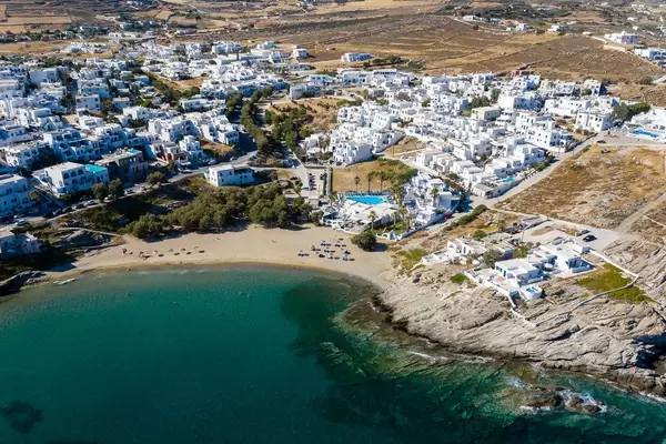 Aerial photography of Naoussa in Greece, with white limestone houses, Piperi Beach and the green Mediterranean Sea