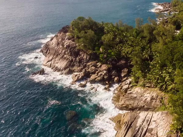 Aerial photography shows waves in front of the bay of Anse des Anglaise near Port Launay in Mahé, Seychellen