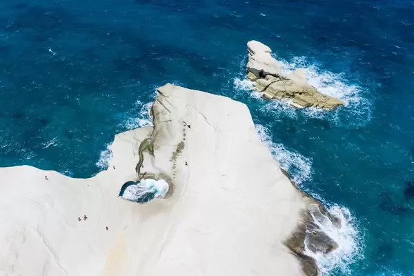 Aerial pic of rock formations in Sarakiniko, Milos. Hole in the cliff, created by strong winds and waves