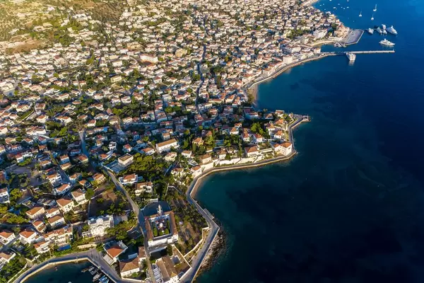Aerial picture of Agios Nikolaos church and ferry bridge of the green island Spetses, Greece, in the Myrtoan Sea
