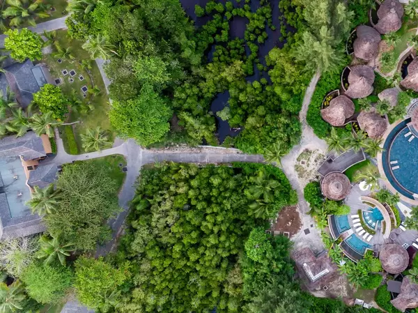 Aerial shot of small trail between Constance Ephelia Resort and its spa area in Mahé, Seychelles