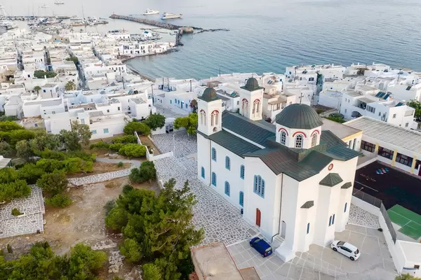 Aerial shot of the colorful limestone main church and fishing port in Naoussa on Paros Island (Greece)
