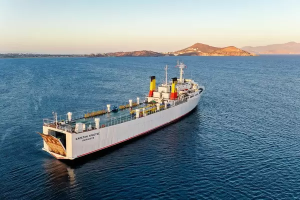 Aerial shot of the Greek cargo ship Kapetan Christos departing from the harbour of the island Naxos