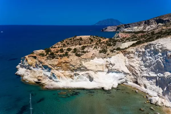 Aerial shot: spectacular cliffs by the beach of Agios Ioannis on the southwest coast of Milos, Greece