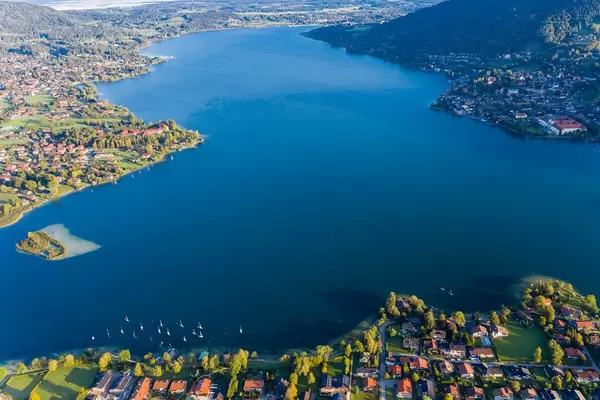 Aerial view encompassing much of the Tegernsee lake in Bavaria with the towns on its shores