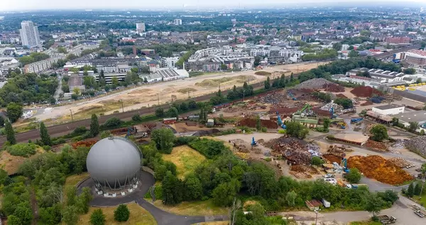 Aerial view of a large construction site with various cranes on Maarweg in Cologne Ehrenfeld, Germany, next to the railway tracks