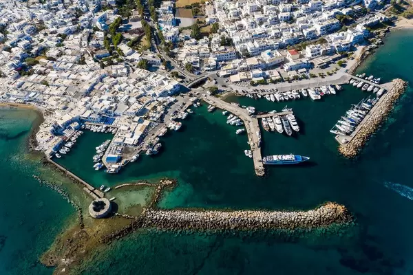 Aerial view of a Venetian castle ruin in the deep blue Mediterranean Sea, in front of the sea port Naoussa on the Greek island Paros
