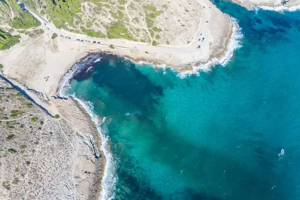 Aerial view of beach with shallow waters, fine sand and scanty vegetation. Cala Mitjana, Artà, Mallorca